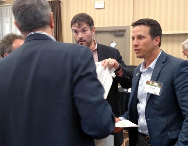 David Groelle, left, listens while John Heywood, center, and Ryan Swilley emphatically make their point during an SBI exercise.