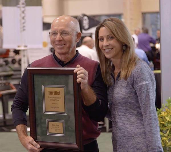 Stephanie Schwenke of Syngenta presents Dick Gray with the 2016 TurfNet Superintendent of the Year Award.