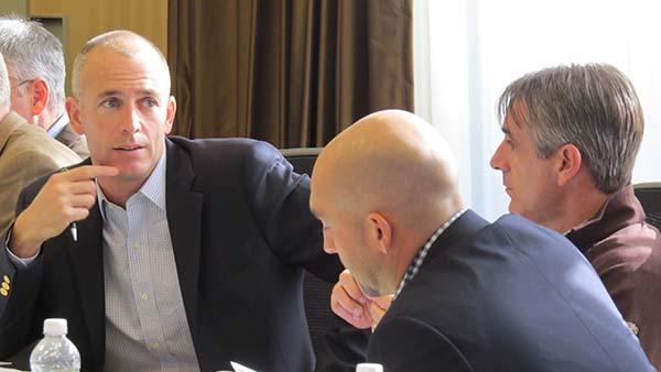 Jeff Corcoran, Nathan Fair and John Cunningham, left to right, polish their negotiating skills at SBI.