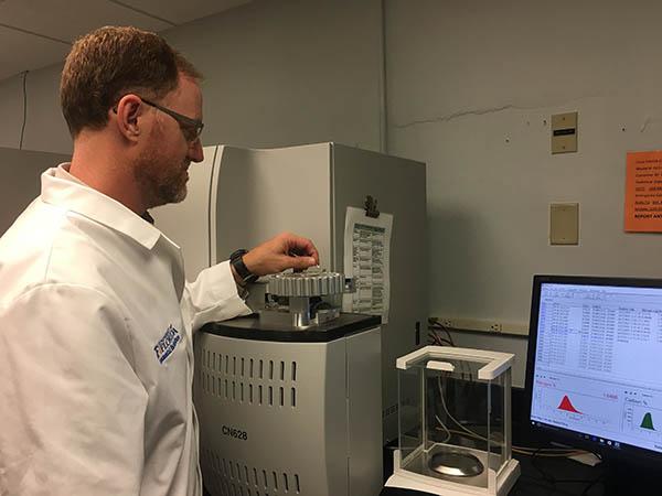 Travis Shaddox, Ph.D., of the University of Florida Fort Lauderdale Research and Education Center, analyzes nitrogen levels in turf tissue samples using a Leco Carbon/Hydrogen/Nitrogen Determinator.