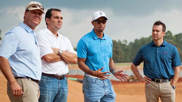 Superintendent Eric Bauer, Andy Mitchell, president of Lantern Asset Management, and Brandon Goodyk, director of development (from left) listen as Tiger Woods discusses the Bluejack National project.
