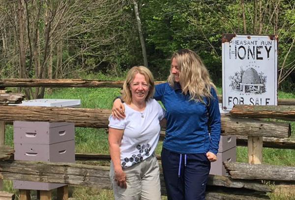 Pheasant Run Golf Club superintendent Leasha Schwab, right, with her mother, Laurie Simard, at the club's beekeeping operation.