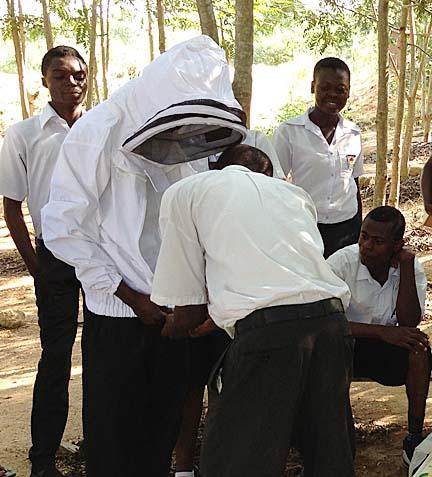 Students in Ghana try out the beekeeping suits they received from Scott Witte.