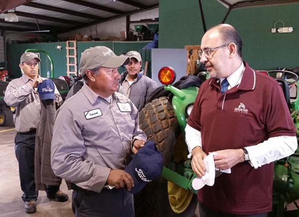 Mexican Consul General Octavio Tripp, right, visits the maintenance staff at Southern Oaks Country Club in Burleson, Texas.