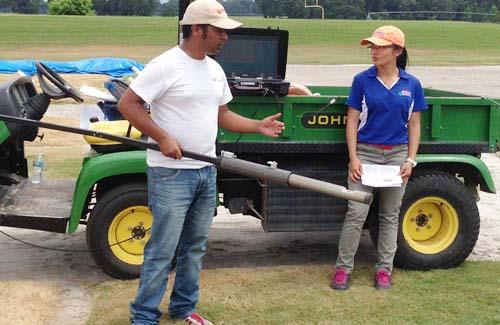 Graduate students Bishow Poudel (left) and Jing Zhang discuss the results of their research on drought- and salt-tolerant grasses.