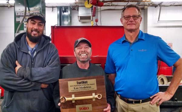 Jim Ferrin, right, and assistant technician Mohammed Nawaz, left, celebrate with 2014 TurfNet Technician of the Year Award winner Lee Medeiros.