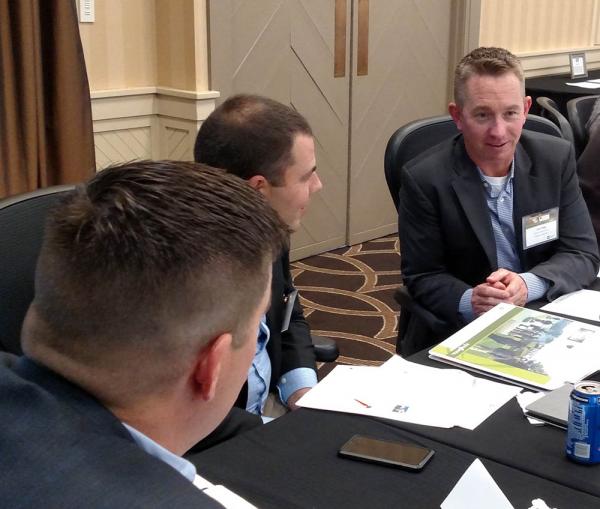 Josh Pope, right, works on a group project at this year's Syngenta Business Institute.