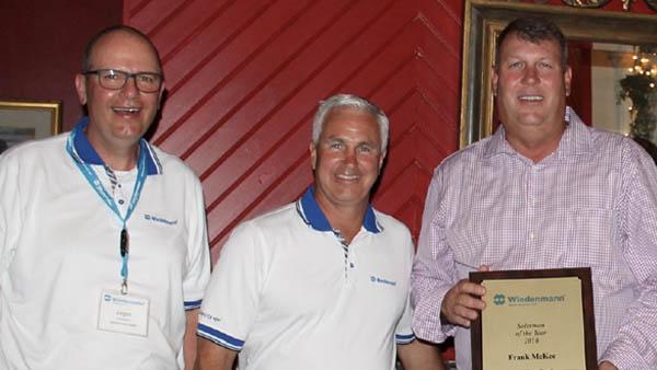 From left, Jurgen Wiedenmann and Will Wolverton present Frank McKee of Everglades Farm Equipment in Belle Glade, Florida, with Wiedenmann North America's Salesman of the Year award.