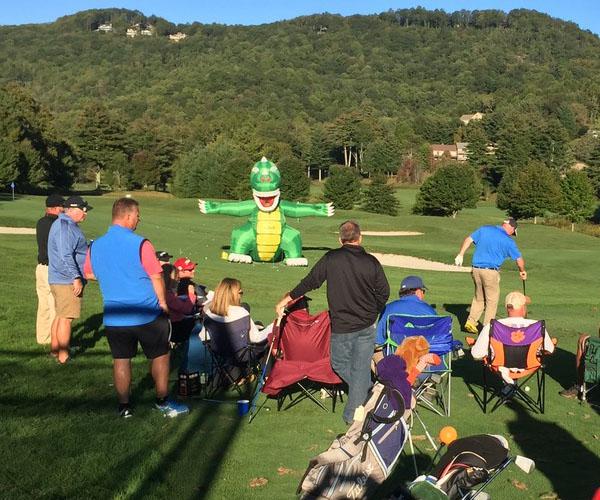 Highlands Cup participants take aim at an inflatable dinosaur as part of the event's skills competition.