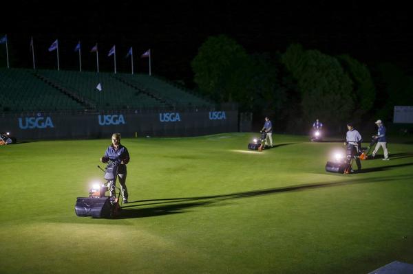 Crews mow No. 18 before sunrise.