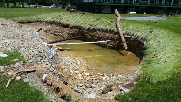 Churning floodwater extricated sand from bunkers throughout the Old White Course, including this one on No. 17.