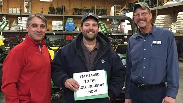 John Cunningham, CGCS, left, and Chris Rapp, equipment manager at Bellerive Country Club, tell Steve Wright of Norwood Hills Country Club that he has won a trip to the Golf Industry Show.