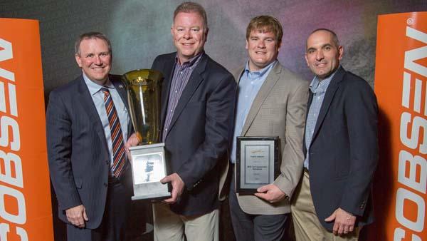 From left, Jacobsen president David Withers presents Tom Houseknecht, Craig Houseknecht and Chris Makowski of MTE Turf Equipment with Global Dealer of the Year award.
