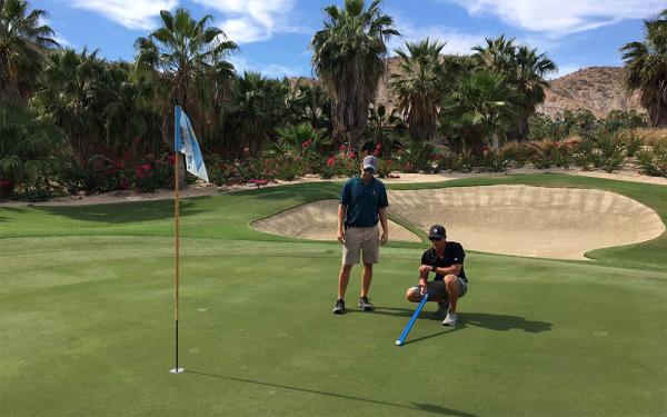 Brian Conlon, left, and Mitch Peterson take a Stimpmeter reading on one of El Dorado's lightning quick greens.