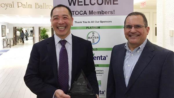 Jose Milan, right, presents Frank Wong, Ph.D., with the TOCA Environmental Communicator of the Year award last May during the group's annual meeting in Tampa, Florida.