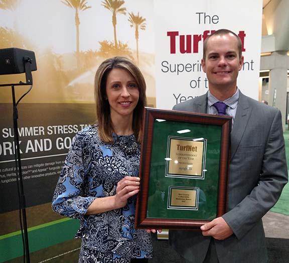 Stephanie Schwenke of Syngenta presents the 2015 TurfNet Superintendent of the Year Award to Matt Gourlay, CGCS of Colbert Hills in Manhattan, Kansas.