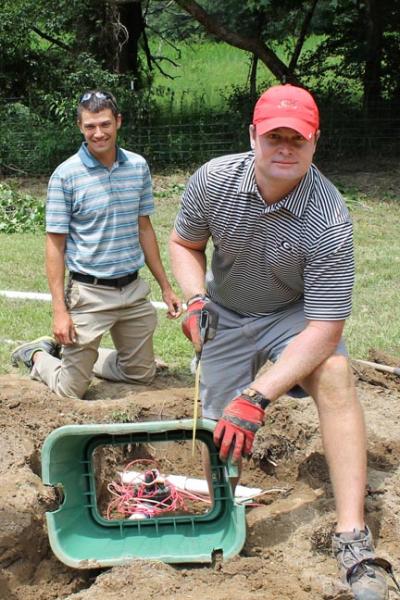 From left, Jason Tharp of Druid Hills Golf Club in Marietta and Scott Griffith of the University of Georgia Golf Club in Athens set irrigation. On the front page, Doug Griffeth of Woodmont Golf and Country Club in Bethlehem totes sod. Photos courtesy of the Georgia GCSA