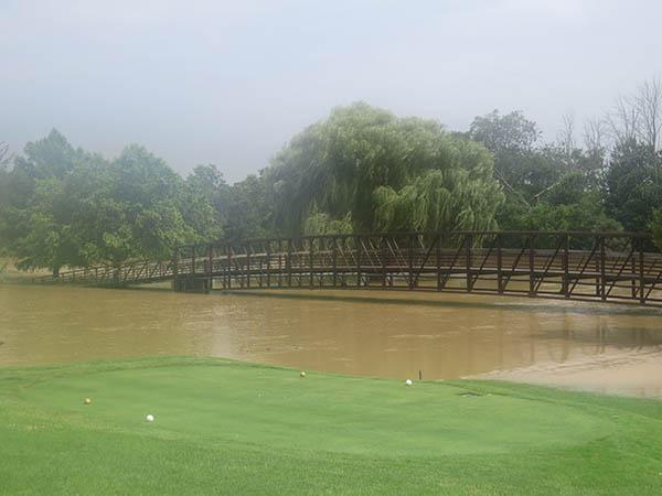 Both ends of bridge spanning the Blanchard River on No. 18 at Findlay Country Club were under water after recent rains swamped four holes on the course.