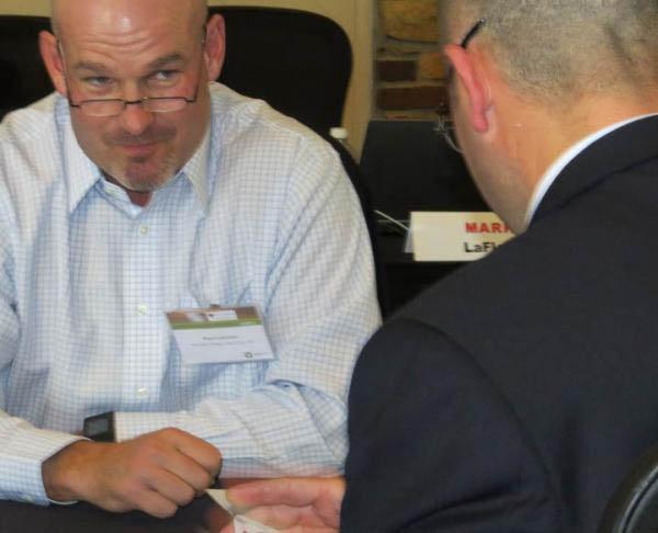 Paul B. Latshaw, left, tries to read Chad Mark's poker face during an exercise at SBI 2015.
