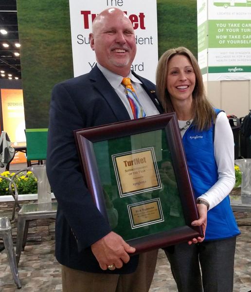 Stephanie Schwenke, turf market manager for Syngenta, presents Rick Tegtmeier, CGCS, with the Superintendent of the Year Award.
